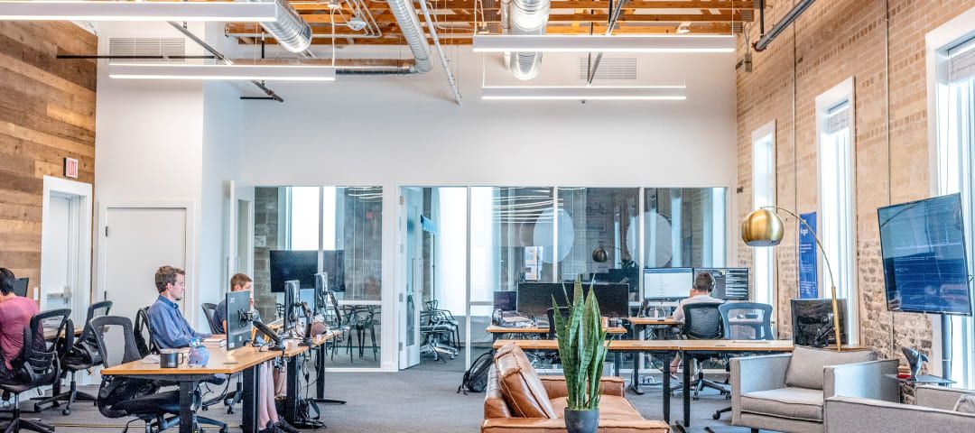 Photo of an office with people working at computers