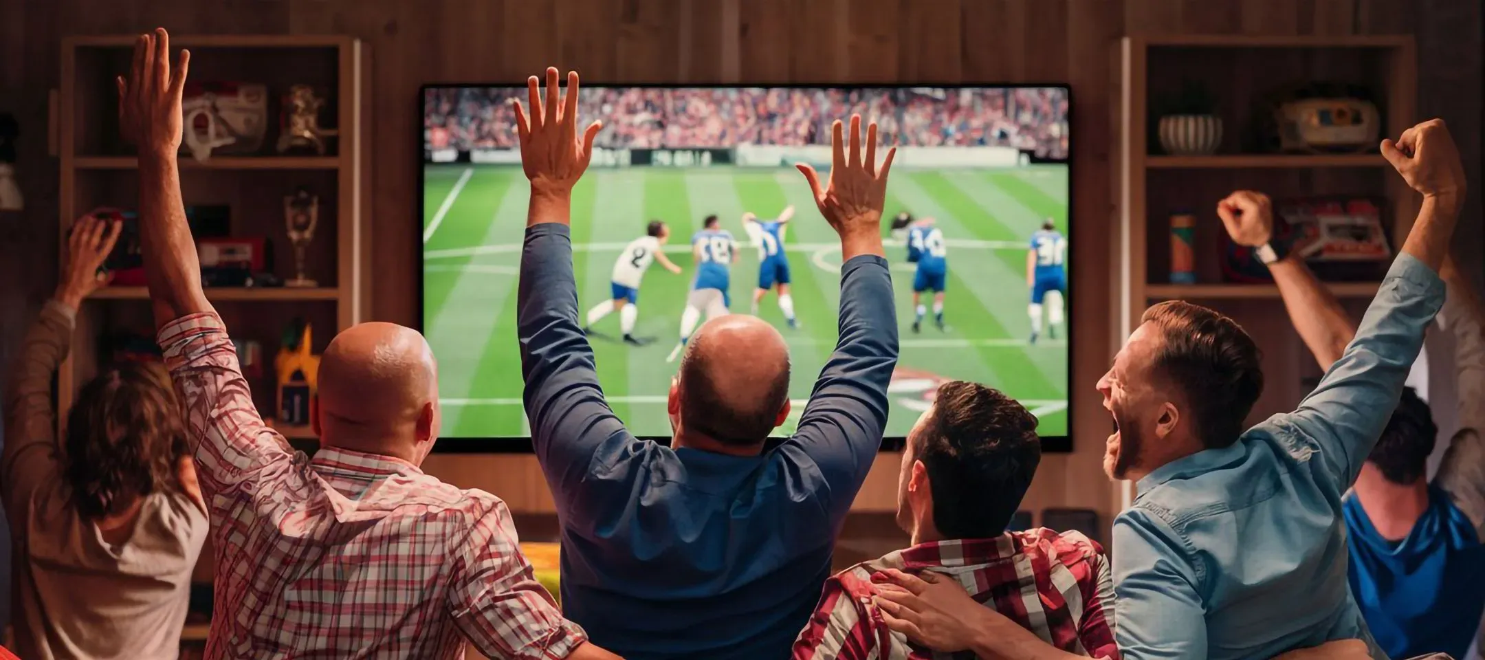 WTC Communications Kingston - Excited sports fans cheering loudly at home watching a thrilling sports game on TV, perfect for residents.