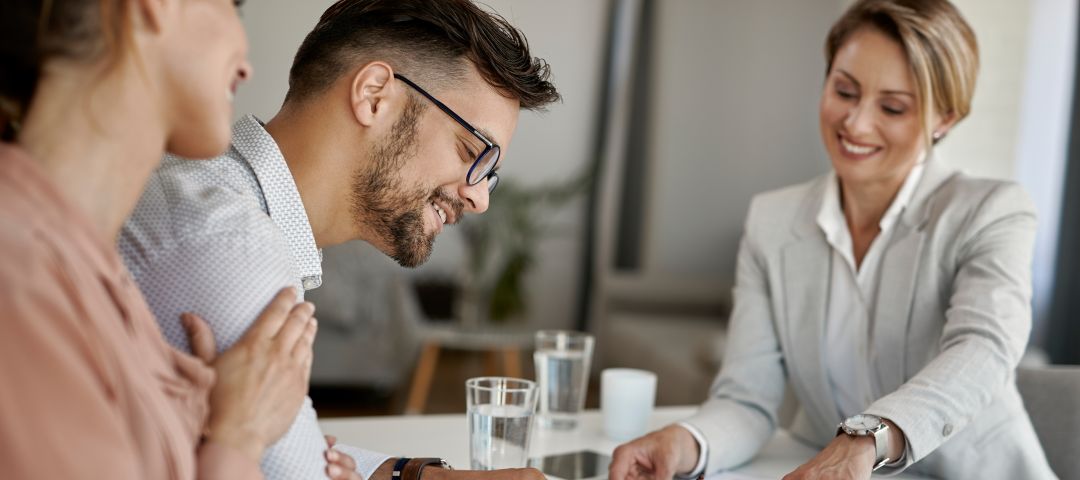 Three People Meeting at a Desk
