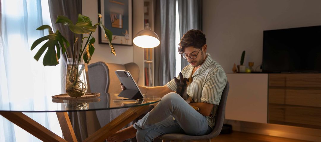 man with tablet and dog in lap