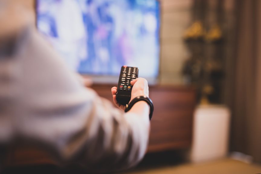Hand Holding Remote to TV