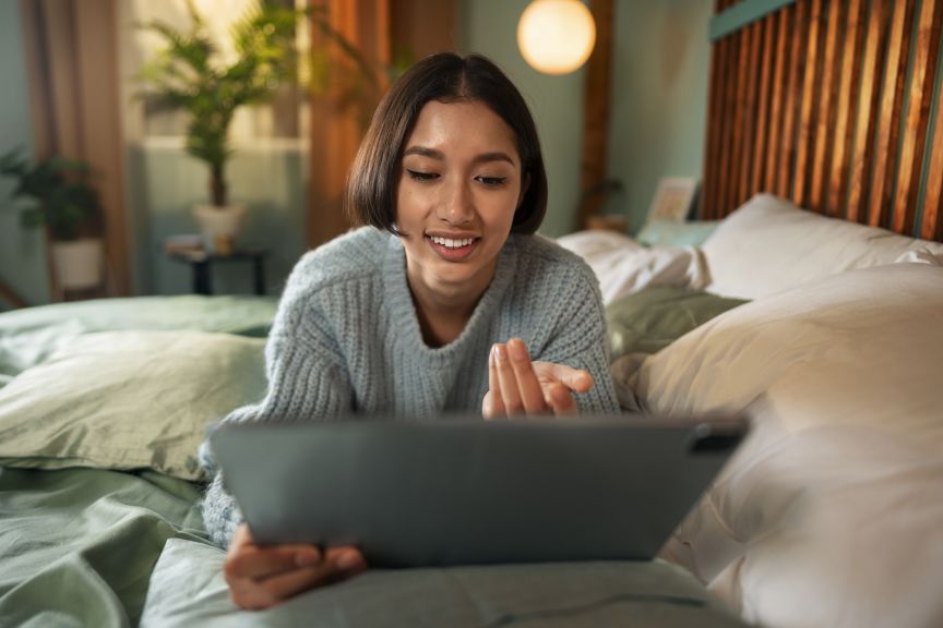 Looking at ipad on bed