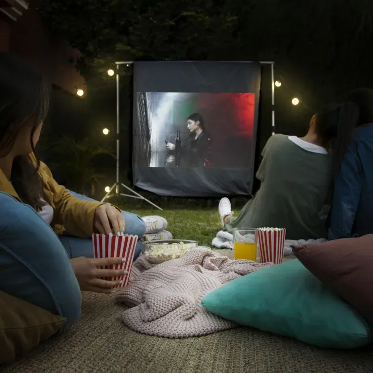 WTC Communications Kingston - Friends having fun Backyard Beacon Outdoor Wi-Fi watching cinema projector.