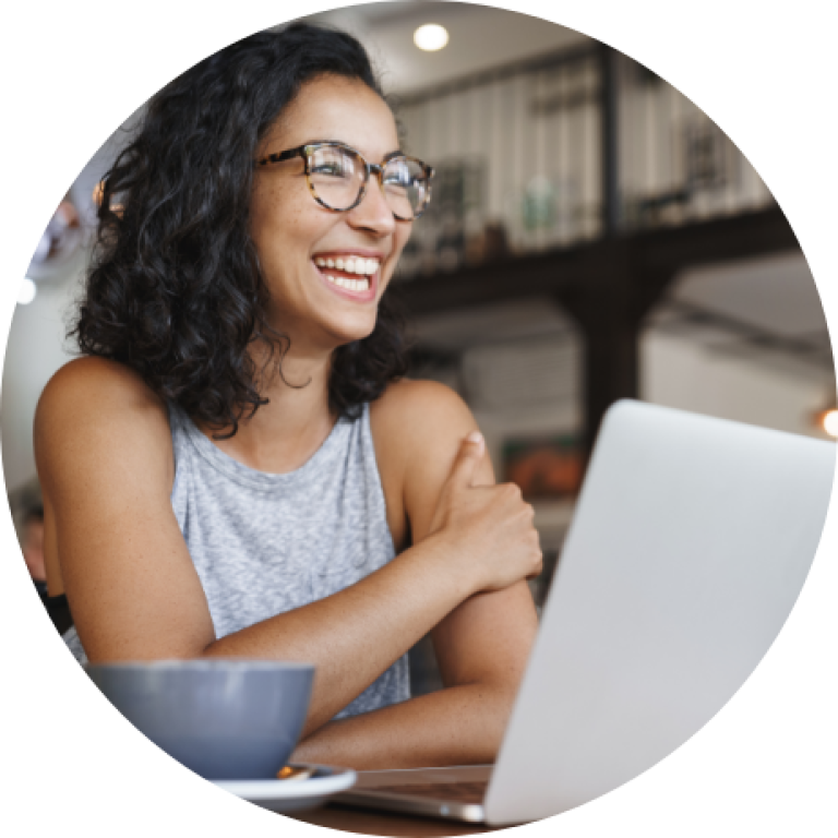 Person Smiling at Laptop