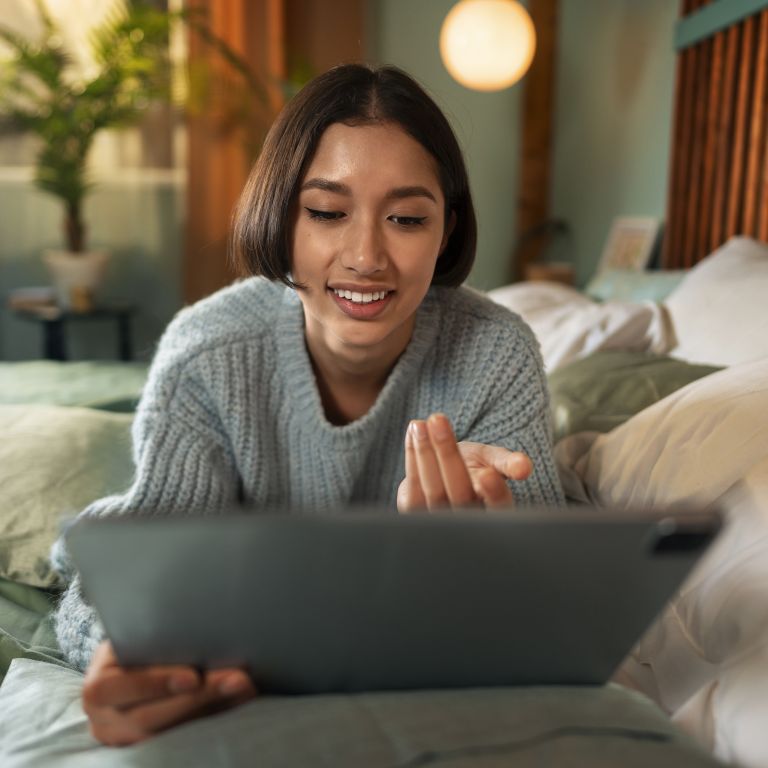 Looking at ipad on bed